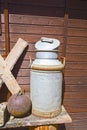 Old milk jug on the wooden wall of a shed