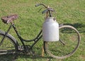 Old bicycle with aluminum milk canister Royalty Free Stock Photo