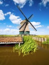 An old mill in the Netherlands. Historical building. A mill near a canal. Dutch architecture and history.