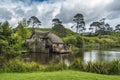 Old mill with pond and green vegetation around Royalty Free Stock Photo