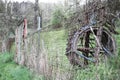 An abandoned mill wheel that contrasts with nature. Royalty Free Stock Photo