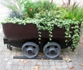 Old mine cart as a decorative flower pot Royalty Free Stock Photo