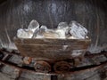 Old mine wagon with illuminated salt stones in Turda salt mine
