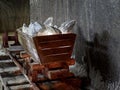 Old mine wagon with illuminated salt stones in Turda salt mine Royalty Free Stock Photo