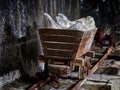 Old mine wagon with illuminated salt stones in Turda salt mine, Royalty Free Stock Photo