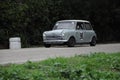 Old Mini Cooper car racing on the road. Royalty Free Stock Photo