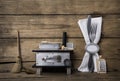 Old miniature of an oven with cutlery on an ancient rustic background for a menu card.