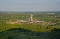 Old mining towers of a coal mine in a green landscape with trees in warm evening light