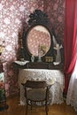 An old mirror in a frame on a table covered with a knitted tablecloth. Royalty Free Stock Photo
