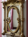 An old mirror in a wooden frame, gilded Royalty Free Stock Photo
