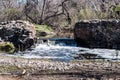 Old Mission Dam with Forest and Stones Royalty Free Stock Photo