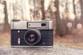 Old 35mm camera in the forest Royalty Free Stock Photo