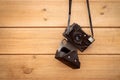 Old 35mm camera hanging on wood wall Royalty Free Stock Photo