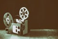 Old 8mm Film Projector over wooden table and textured background Royalty Free Stock Photo