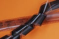 Old 35 mm Photographic film strips, negative on bright orange background, flat lay. Photo, movie cinema concept Royalty Free Stock Photo
