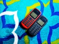 Old Mobile Phone with Texting or SMS Button Keyboard or Keypad on Colorful Carpet Background Royalty Free Stock Photo