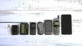 Old mobile phones and pagers isolated on white wooden background Royalty Free Stock Photo