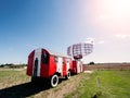 Old mobile radar station painted in red and white color. Blue sky background. Airport space control and coordination. Modern Royalty Free Stock Photo