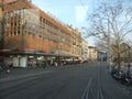 Old and modern buildings, dry trees, street, people walking in the tourist city of Zurich Royalty Free Stock Photo