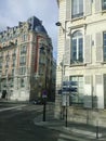 Old and modern buildings, traffic signs, street and car in the tourist city of Paris