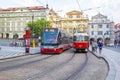 Old and modern trams on main square of Prague`s Mala Strana next to St. Nicholas Church Royalty Free Stock Photo