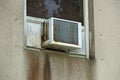 Old moldy rusted air conditioner in window Royalty Free Stock Photo