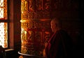 Old Monk Rotating a Prayer Wheel