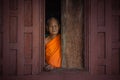 Old monk standing at wood window, Ratchabuir - Thailang