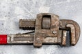 Old Monkey wrench isolated on cement background Royalty Free Stock Photo