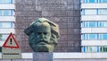 Sign Communism german `Kommunismus` in Front of Karl Marx Head Chemnitz Germany