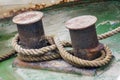 Old mooring bollard with heavy ropes Royalty Free Stock Photo