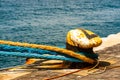 Old mooring bollard with heavy ropes in the port of Gibraltar. Mooring end of a rope anchoring a ship Royalty Free Stock Photo