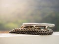 Old mooring rope tied around an aluminium cleat on the boat. Royalty Free Stock Photo