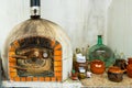 Old Moorish oven with rusty metal door with accessories and ceramic tableware