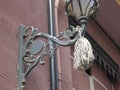 Old mop hanging on a lantern on a wall in the streets of Alicante