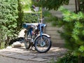 Old moped near the barn in the park Royalty Free Stock Photo