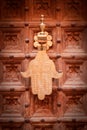 Old Moroccan door handle, copper hand on carved wooden door Royalty Free Stock Photo