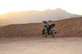 Vintage grey motorcycle in the desert at sunset Royalty Free Stock Photo