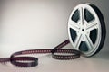 Old motion picture film reel on brown background