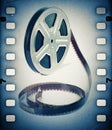 Old motion picture film reel with film strip. Royalty Free Stock Photo