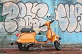 Old motorbike in front of graffiti wall Royalty Free Stock Photo