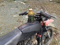 an old motorbike with a modified gas tank using an old bottle Royalty Free Stock Photo