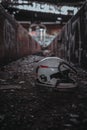 Old motorcycle helmet on the ground inside a derelict building.