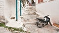 Old motorcycle on narrow white stone streets