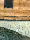 Old mountain cottage facade decorated with stone and wood Royalty Free Stock Photo