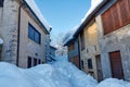 Old mountain houses half-buried by falling snow Royalty Free Stock Photo