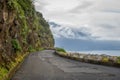 Old mountain road between mountains and ocean at Madeira island. Royalty Free Stock Photo