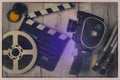 Old movie camera, clapperboard and film on a reel Royalty Free Stock Photo