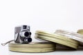 Old movie camera and film canisters on white Royalty Free Stock Photo