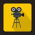 Old movie camera with reel icon, flat style Royalty Free Stock Photo